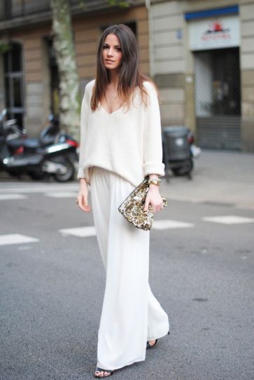 25 Winter White Outfits to Try - wide leg trousers worn with a v-neck sweater + gold sequin clutch: 